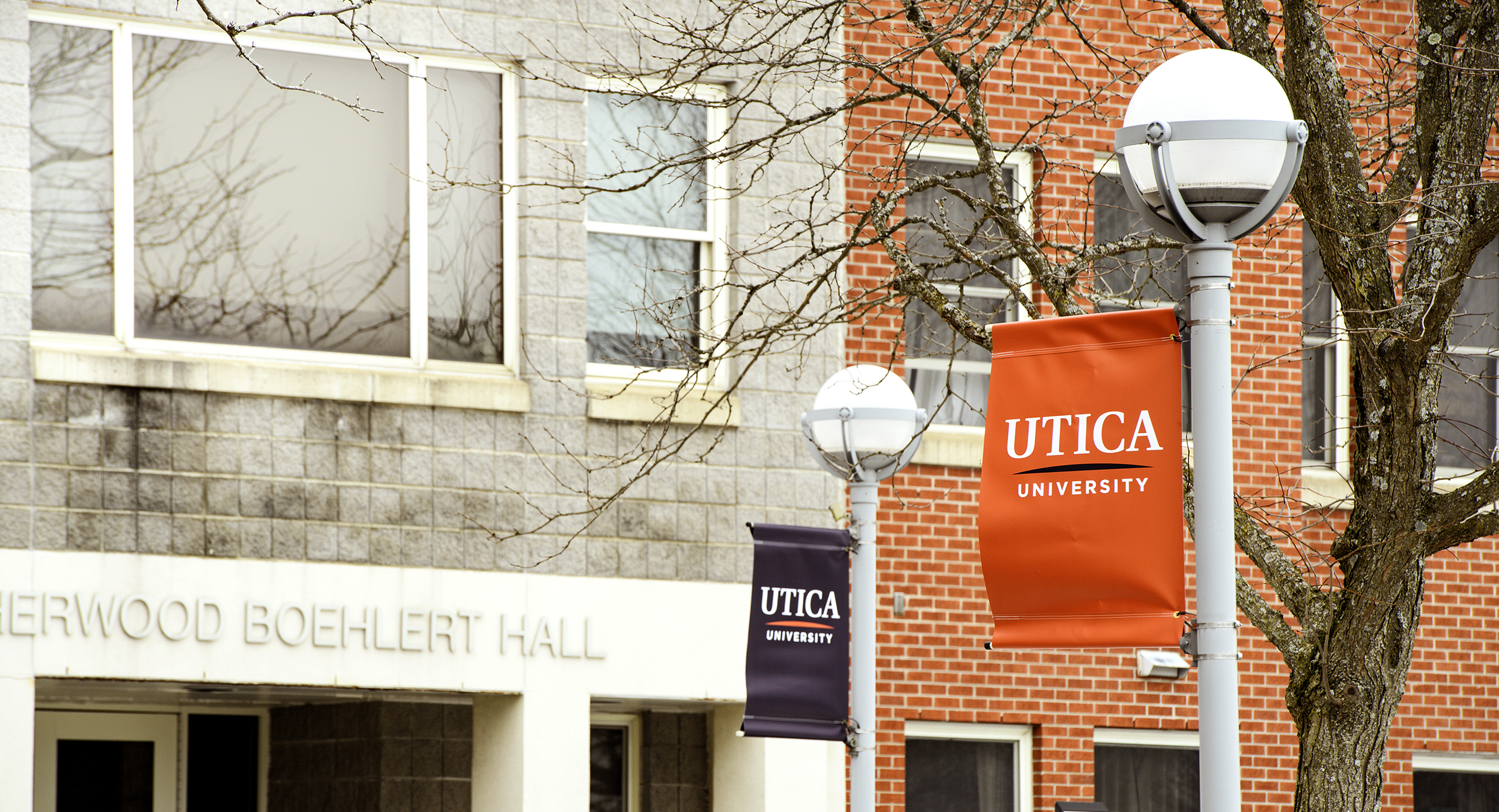 Orange banner on post in front of residence hall